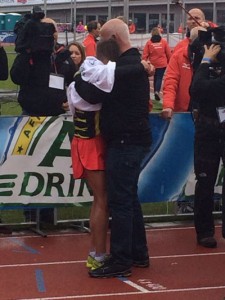 Race director Cees Pronk comforts the exhausted and heartbroken Butter after the athlete just missed qualifying for Rio
